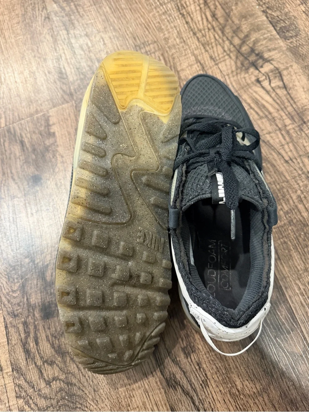 Nike Black Sneaker with White Swoosh and Yellowed Midsole
